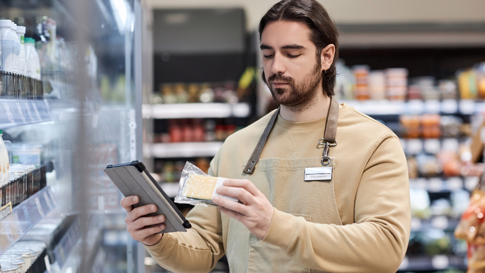 A person using a tablet to compare product prices
